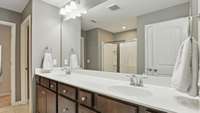 Master bath has double vanities, an extra-large shower, and a linen closet!