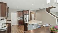 Kitchen has granite countertops, a beautiful backsplash, stainless steel appliances, a large walk-in pantry, and upgraded wood floors!