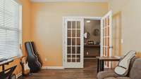 The office has glass French doors and lots of natural light! It is currently used as a music room!