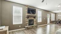 Livingroom has a beautiful stone fireplace and upgraded wood floors!