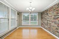 The large sunroom features a charming brick accent wall and crown molding that add character to the space. 101 Bane Dr.  Smyrna, TN 37167