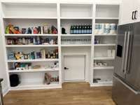 Pantry with abundant storage and an easy access door to receive groceries from the garage