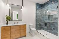 Full bath with shower for secondary bedroom also serves as pool bath with access door to the exterior.