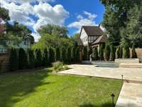 Back yard is large and landscaped with fence painted to match siding of home