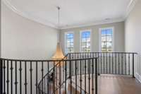 Landing at Top of Dramatic Curved Staircase Overlooking 2-Story Foyer