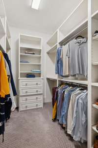 You Will Love the Two Large Primary Bedroom Closets with Custom Closet Built-ins & Drawers