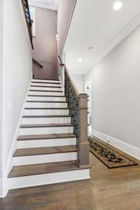 Convenient Back Staircase Leads to Libray Loft