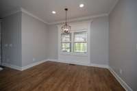 Large breakfast room with plantation shutters and exquisite woodwork.