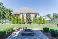 Off of the covered back porch is a wonderful fire pit and great yard!