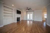 Large den with fireplace, built-ins and french doors to back covered patio.