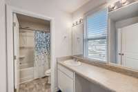 Lots of counter space in this full bath shared by bedrooms 2 & 3