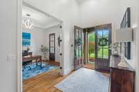 As you enter, you're welcomed by rich hardwood floors, soaring ceilings, custom built-in shelving, and striking ironwork.