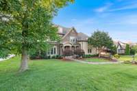 This charming home is surrounded by mature trees, vibrant green lawns, and carefully designed landscaping!