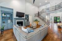 This inviting living space features an updated color scheme, iron work designs, and an open space for connecting and relaxing.