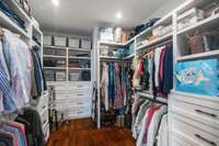 This extra-large walk-in closet is complete with built-ins and plenty of shelving, perfect for keeping clothing and accessories beautifully arranged.