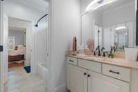 This well-appointed Jack and Jill bathroom offers dual entrances and ample space, ideal for shared use without sacrificing privacy.
