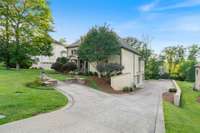 A spacious driveway provides ample parking for multiple vehicles with ease.