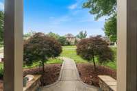 Nestled on a spacious lot, this charming home is surrounded by mature trees, vibrant green lawns, and carefully designed landscaping.