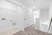 Laundry and linen closet in upstairs hallway
