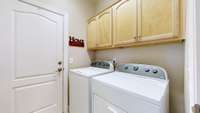 Laundry room with closet and cabinets