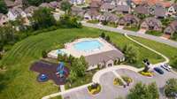 HOA amenity center with playground, benches, two pools