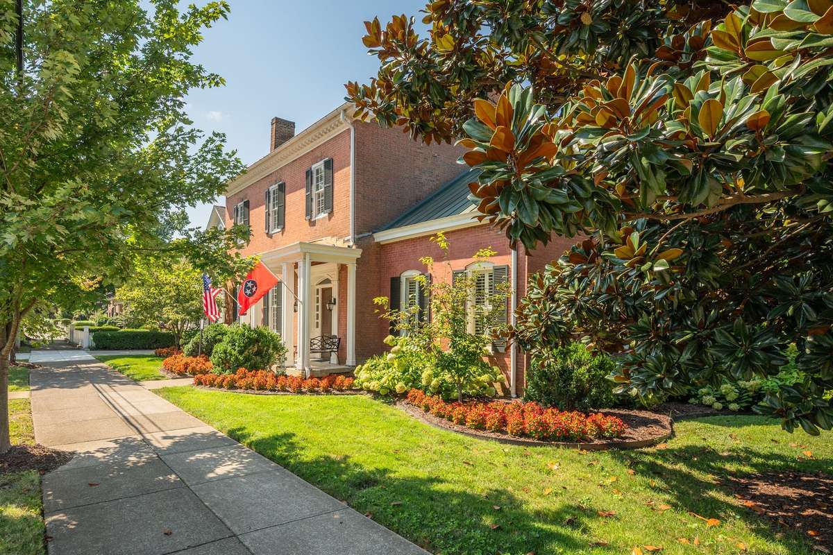 Framed with beautiful mature southern trees and glorious landscaping you are invited in to  see this jewel of Franklin.