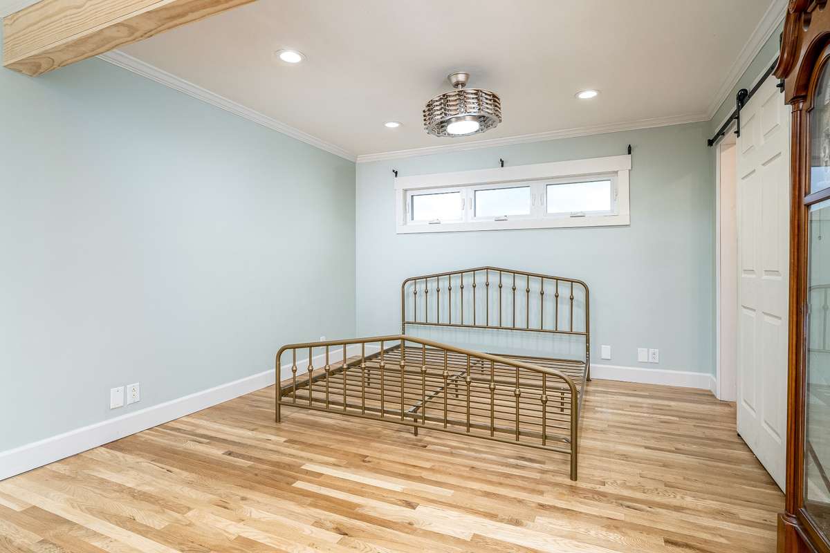 Primary Suite with exposed wood beams in the ceiling