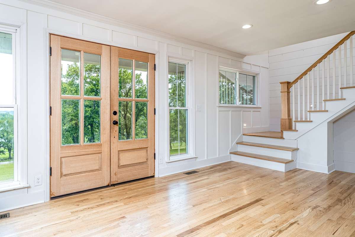 Double front doors leads to the Family Room, Dining Room and Kitchen Combo. Beautiful wood stairs leading to the 2nd story.