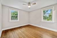The primary bedroom features large windows that overlook the back yard and bring in tons of natural light.