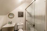 The full bath features a stainless vanity and walk in shower.