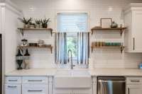 Totally renovated kitchen with quartz counters, and a porcelain farmhouse sink.