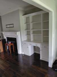 Custom built-in with fireplace and hardwoods throughout.