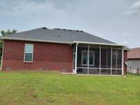 All brick home with screened in back porch and level backyard.
