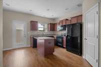 Kitchen with all appliances.  Back door leads to small patio, storage closet and 2 designated parking spaces.