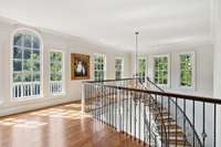 Spiral staircase landing above the foyer-