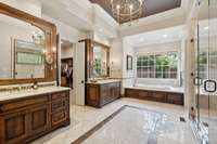 Separate vanities, designer sconces and lighting, crown molding, decorative tile flooring