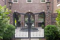 Couryard with iron gates and gas lanterns