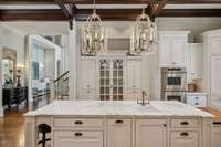 Custom cabinetry with abundant built in's, marble countertops, designer lighting and stainless steel appliances.