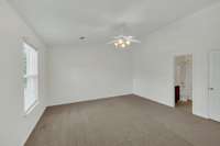 Other side of the main bedroom with the ensuite bathroom off to the right