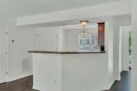 Kitchen is to the right of the foyer entrance. Notice the bar seating as well