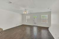 Open concept den with lots of light. Built in blinds in the back door as well as blinds in each of the windows will remain