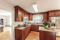 The kitchen leads directly into another living area.