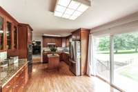 Large kitchen with granite, double ovens, stainless steel appliances, and plenty of cabinet space.  The sliding glass doors lead you to a patio and a beautiful level backyard.