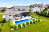 The expansive 40-foot pool features built-in seating in all four corners, offering easy access and multiple spots to relax and unwind.