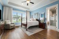 Located on the main floor, the primary suite offers serene views of the backyard and a spacious, thoughtfully designed layout for ultimate comfort and relaxation.