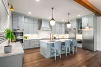 The owners especially enjoy the two-column refrigerator and freezer, which provide generous, organized storage within the high-end appliance suite.