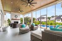 Just off the living room, the covered and screened-in porch features a custom epoxy floor finish—an ideal space for entertaining with BBQs, cozy fireplace evenings, and sunset views overlooking the pool.