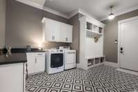 The spacious laundry room is conveniently situated near the primary suite, offering easy access and everyday functionality.