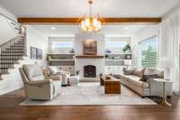 Relax by your own fireplace beneath soaring ceilings adorned with custom-detailed beams in the heart of your living room.