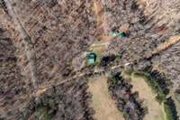 Aerial View showing Log home, 2 car garage, Smoke house and Tractor Shed